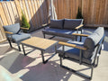 VAKKER Modern 4 Seater aluminum patio set with charcoal grey cushions and polywood coffee table