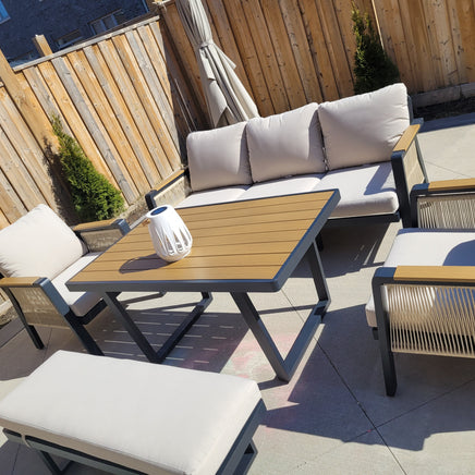 SNAKK SKITTENT Luxury Aluminum Dining Patio Set with teak wood accents and plush cushions in modern outdoor lounge setting