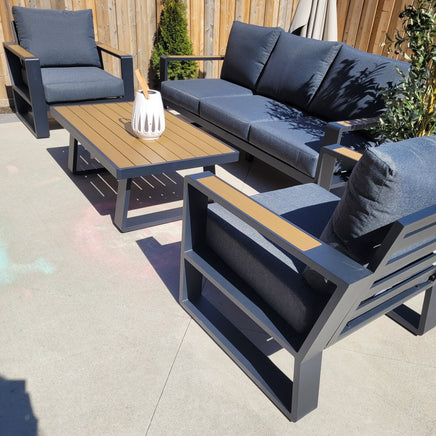 5-seater aluminum patio set with polywood coffee table and weather-resistant cushions on a modern outdoor deck