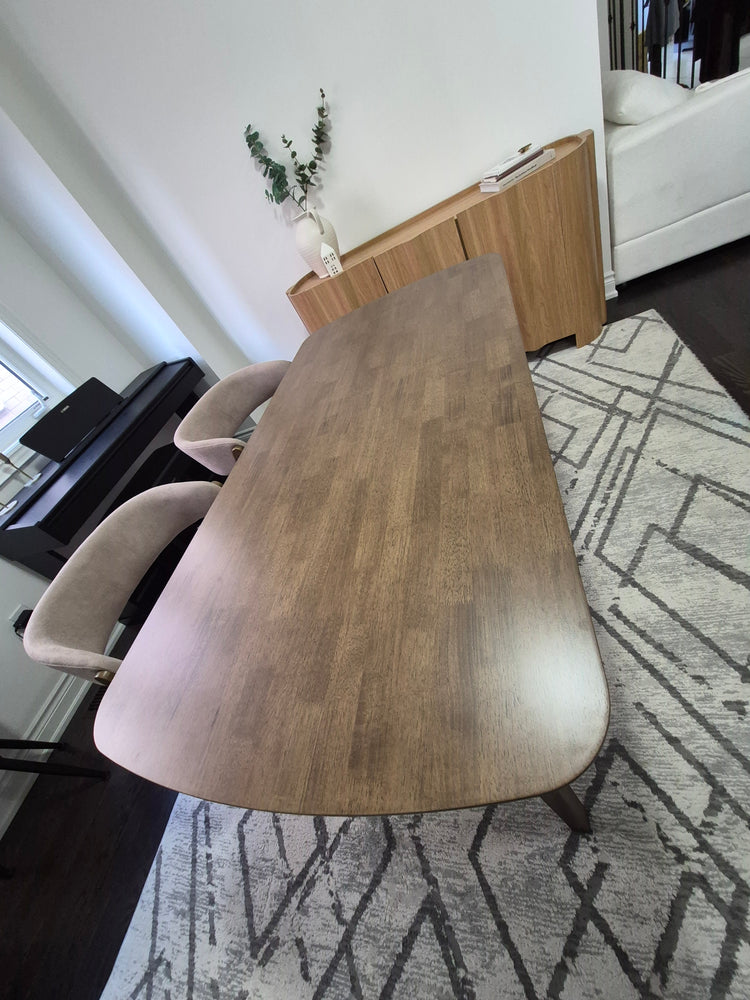 Close-up of ELIO upholstered chair seat and angled wood frame