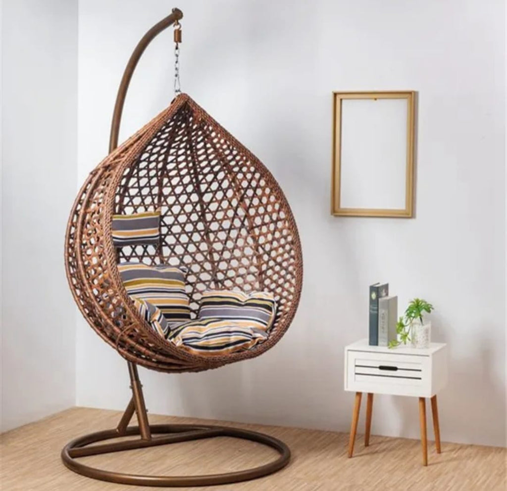 ARDYNAMIC AMARA egg swing chair dark brown hand-woven PE rattan with beige and dark brown cushions on iron stand in modern room